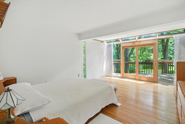 6710 Curtis Rd, Plymouth, MI 48170 - bedroom featuring access to exterior and wood finished floors