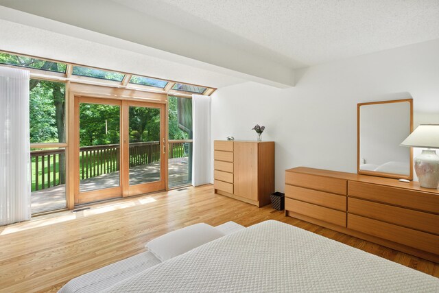 6710 Curtis Rd, Plymouth, MI 48170 - bedroom with access to outside, wood finished floors, and a textured ceiling