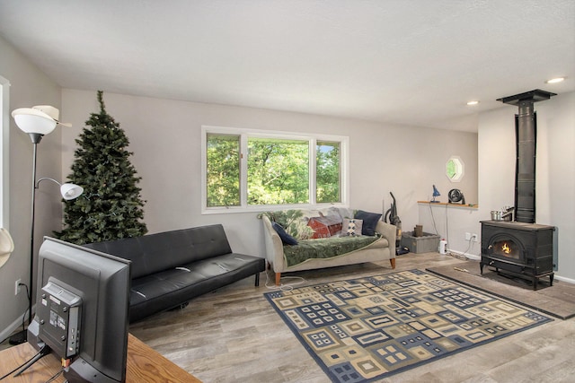 living room with hardwood / wood-style flooring and a wood stove