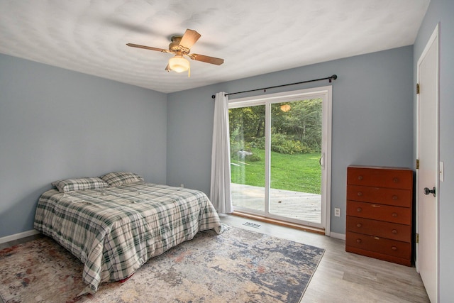 bedroom with ceiling fan, light hardwood / wood-style flooring, and access to exterior