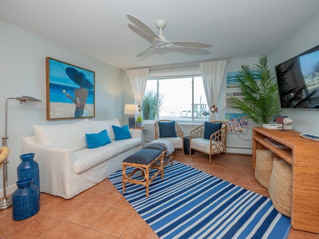 living room featuring baseboard heating, ceiling fan, and tile patterned floors