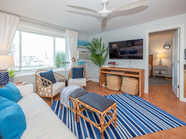 tiled living room featuring baseboard heating, ceiling fan, and cooling unit