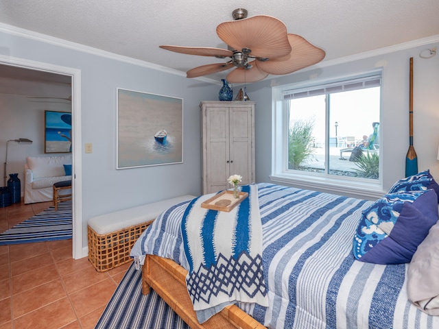 bedroom with a textured ceiling, ceiling fan, ornamental molding, and light tile patterned flooring