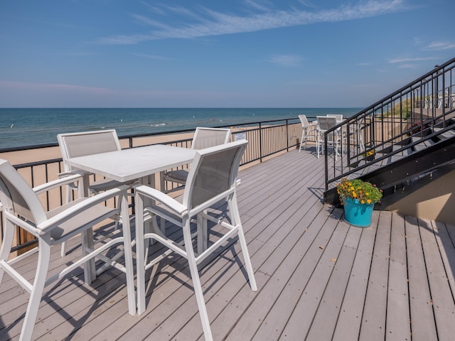 wooden terrace featuring a water view