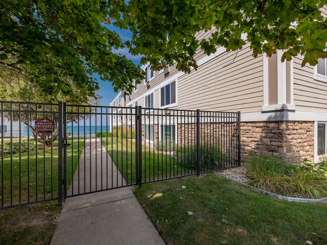 view of gate with a yard