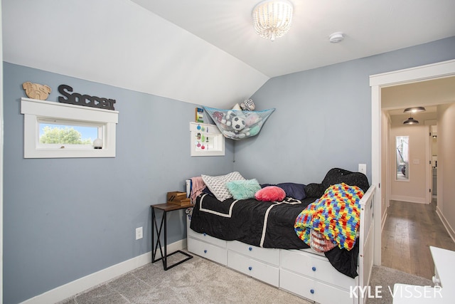 bedroom featuring vaulted ceiling and baseboards