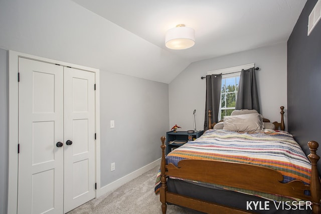 bedroom featuring vaulted ceiling, carpet flooring, visible vents, and baseboards