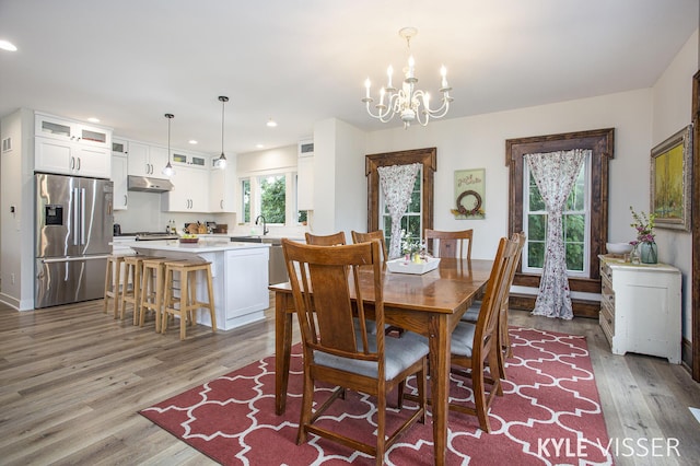 dining room featuring recessed lighting, a notable chandelier, baseboards, and wood finished floors