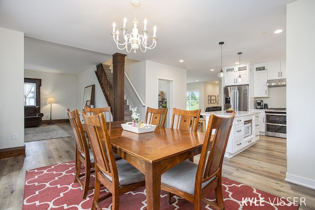 dining area featuring light wood-style floors, stairs, baseboards, and recessed lighting