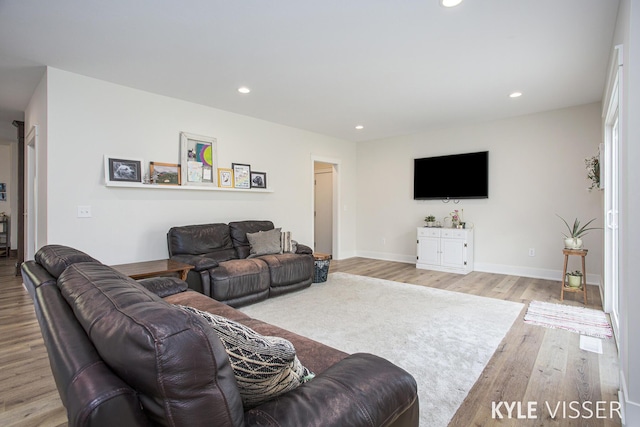 living room with baseboards, wood finished floors, and recessed lighting