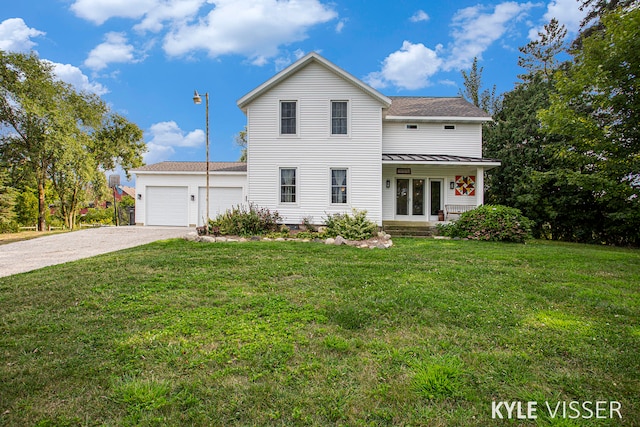 view of front of property with a front lawn and a garage