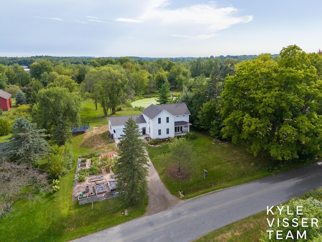 birds eye view of property with a view of trees