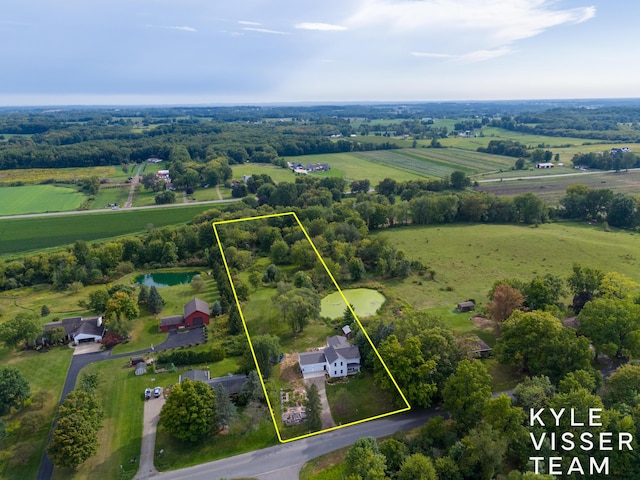 birds eye view of property with a rural view