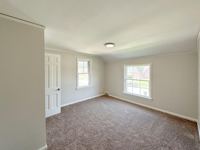 unfurnished room featuring carpet and crown molding