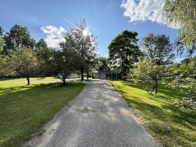 view of front of property with a garage and a front lawn