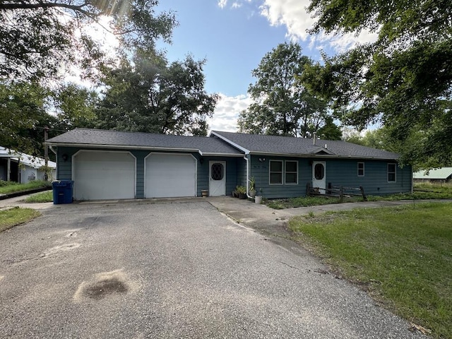 ranch-style house with an attached garage and driveway