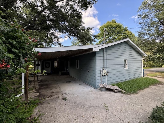 view of home's exterior with an attached carport and concrete driveway