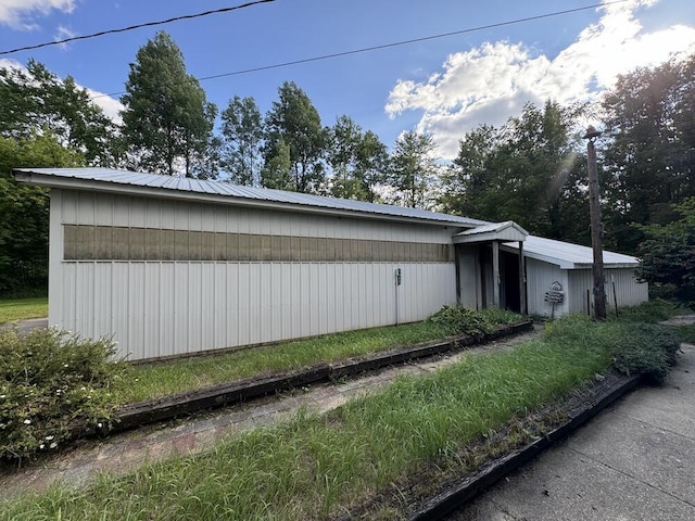 view of side of home featuring metal roof