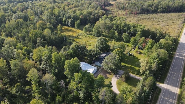 drone / aerial view featuring a view of trees