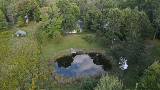 aerial view featuring a wooded view and a water view