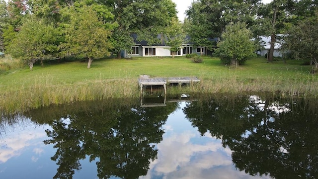 view of dock featuring a yard and a water view