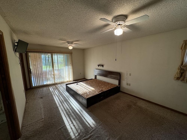 unfurnished bedroom with baseboards, carpet floors, a textured ceiling, and ceiling fan