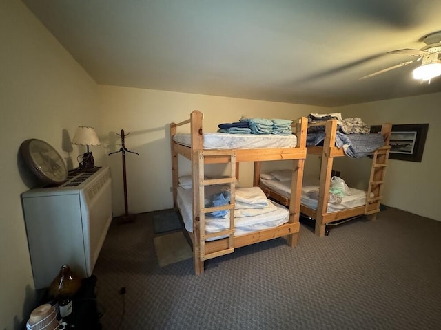 carpeted bedroom featuring ceiling fan and vaulted ceiling