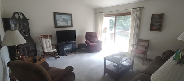 living room featuring lofted ceiling and light carpet