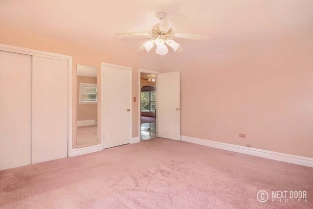 unfurnished bedroom with a closet, ceiling fan, and carpet