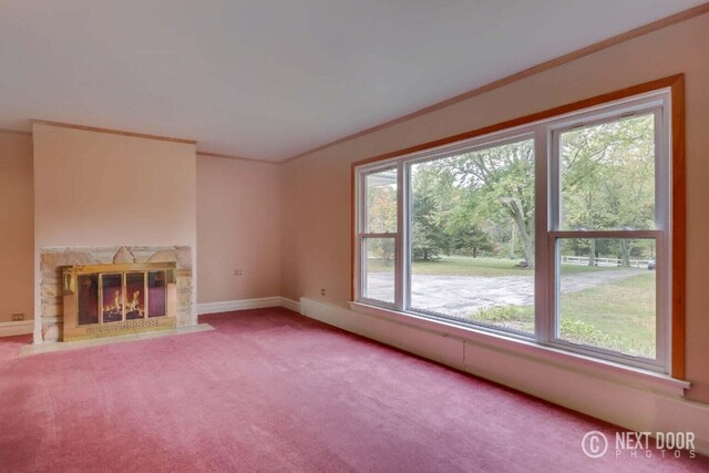 unfurnished living room with a fireplace, a wealth of natural light, and carpet flooring