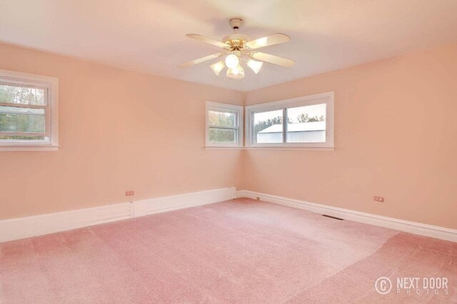 unfurnished room featuring ceiling fan and carpet