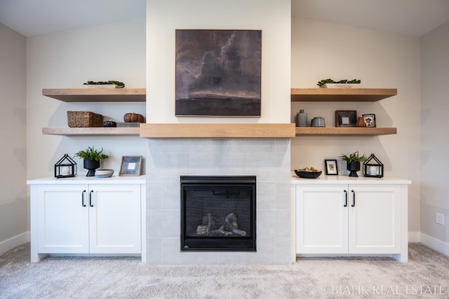 carpeted living room featuring lofted ceiling and a fireplace