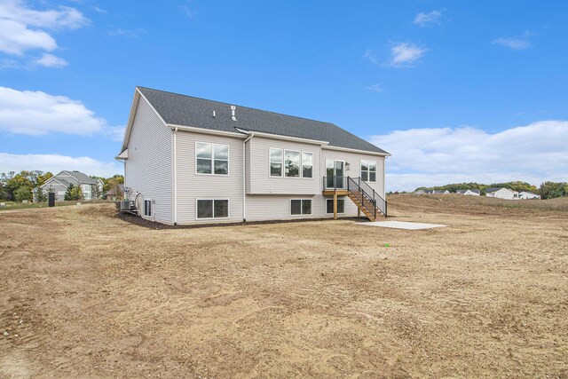 back of house with central AC unit