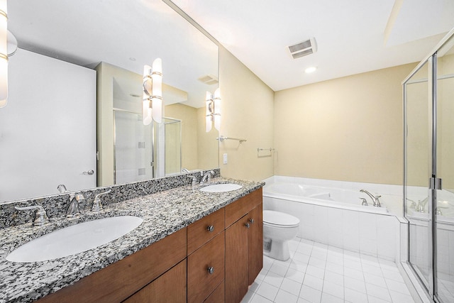 bathroom featuring a garden tub, double vanity, a sink, and visible vents