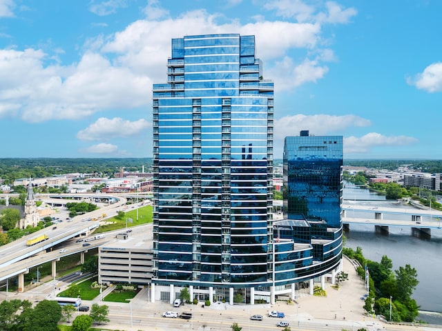 view of property featuring a water view and a city view