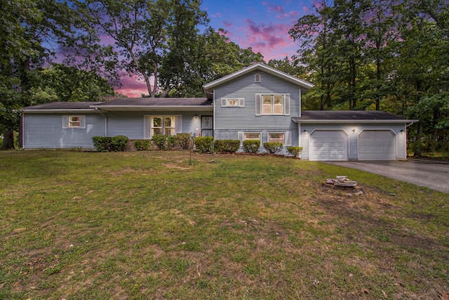 view of front facade featuring a lawn and a garage