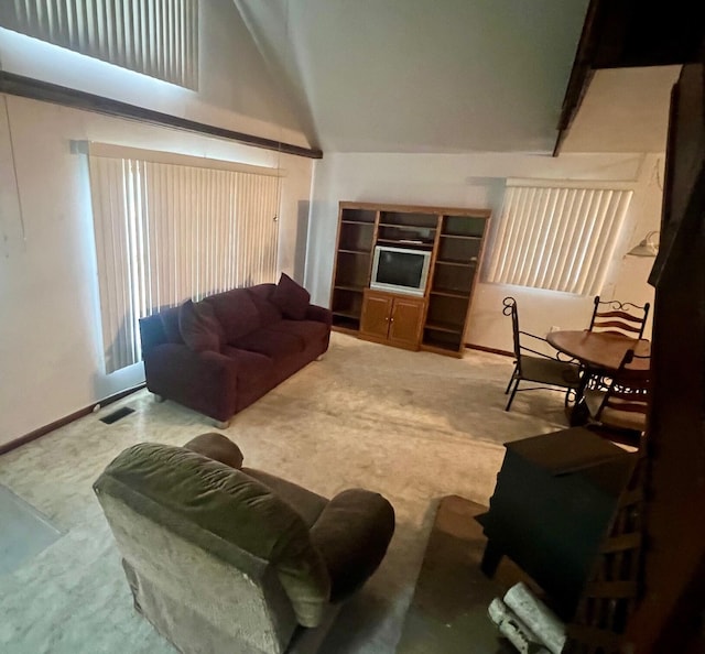 carpeted living room featuring high vaulted ceiling