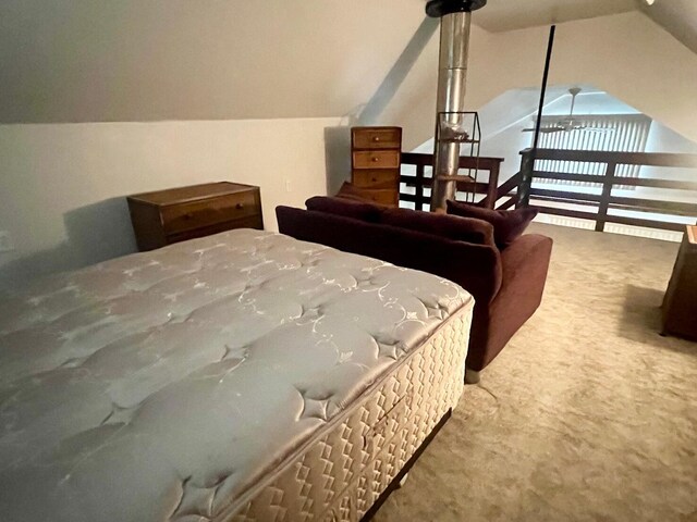 bedroom featuring lofted ceiling and carpet