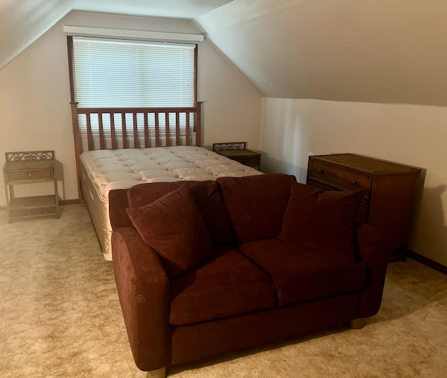 carpeted bedroom with lofted ceiling