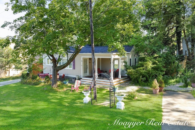 bungalow with a front yard, covered porch, and a shingled roof