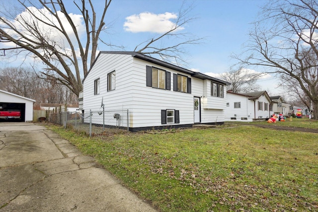 view of home's exterior featuring an outdoor structure, a garage, and a yard