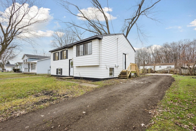 view of side of home featuring a lawn