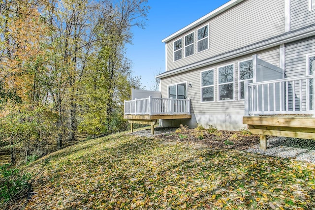 back of house with a wooden deck