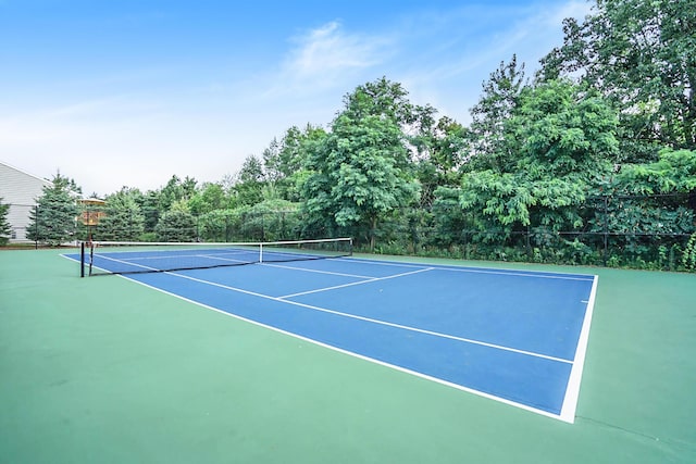 view of tennis court with fence