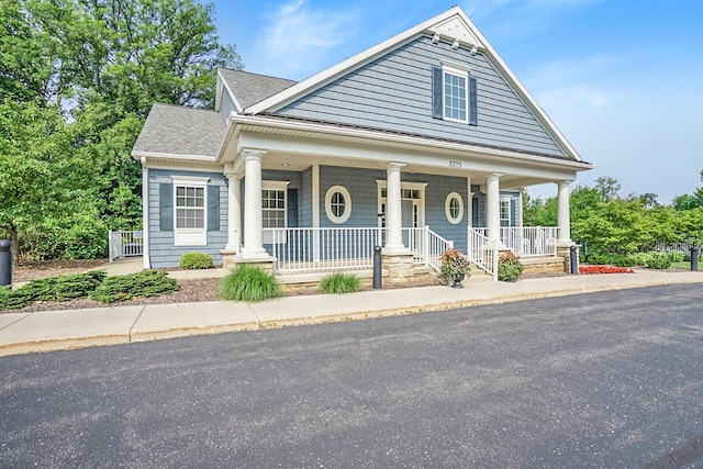 view of front of property with covered porch and a shingled roof