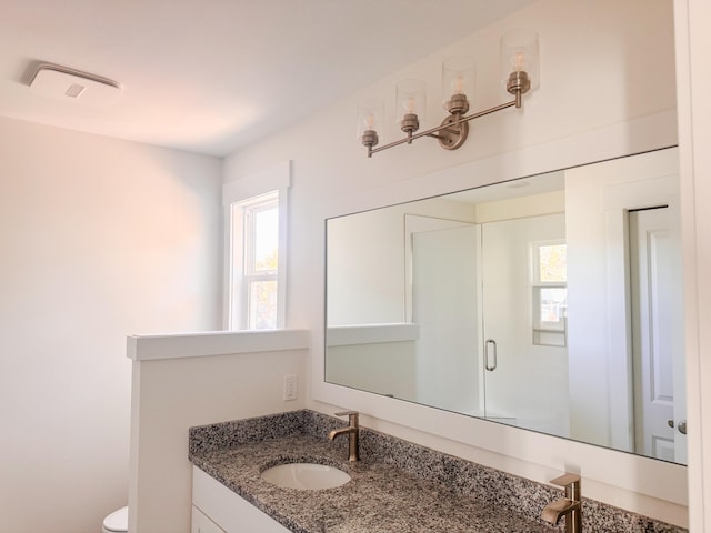 full bath featuring toilet, a stall shower, visible vents, and vanity