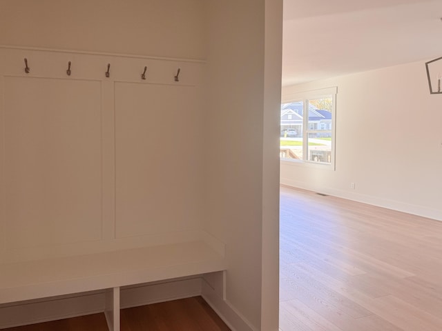 mudroom with wood finished floors and baseboards