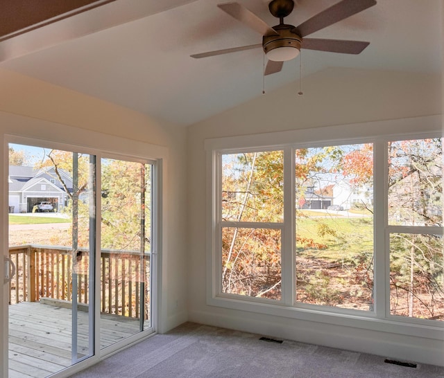 unfurnished sunroom featuring a ceiling fan, lofted ceiling, and visible vents