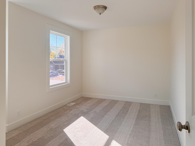 unfurnished room featuring carpet floors and baseboards