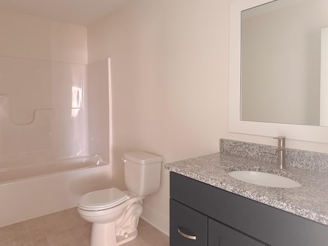 bathroom with toilet, vanity,  shower combination, baseboards, and tile patterned floors